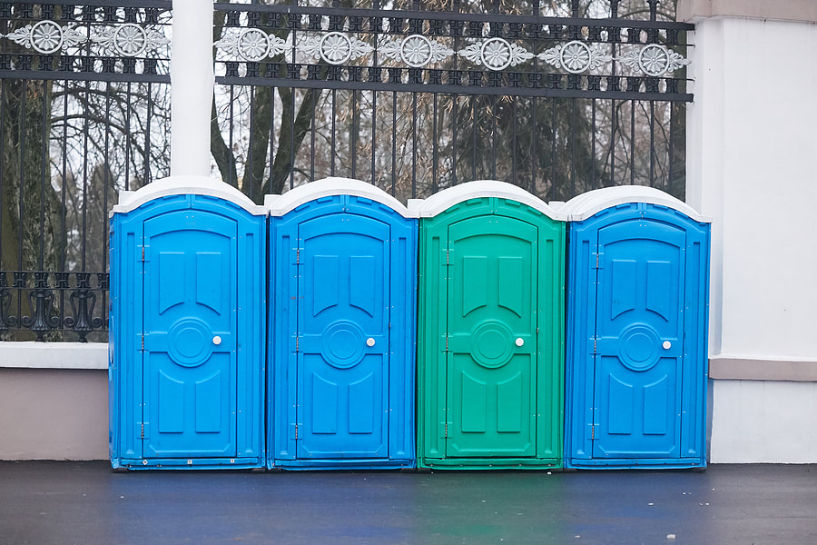 portable toilets beside the fence